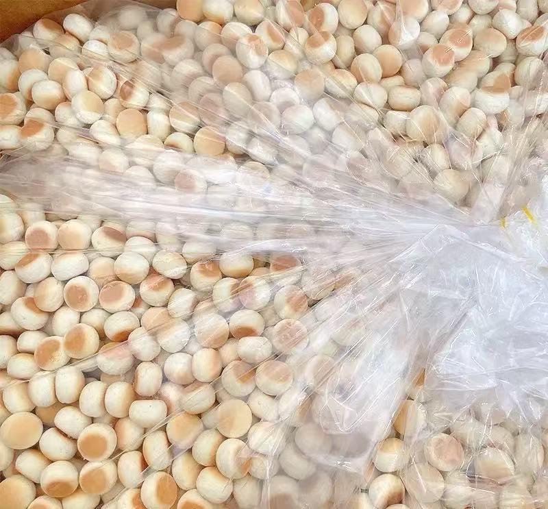 Small round snack products packed in a clear liner inside a carton