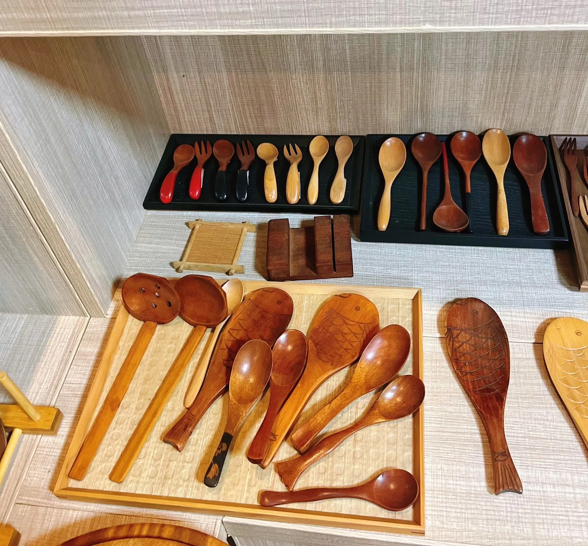 Wooden spoons, forks and kitchen utensils displayed for product review