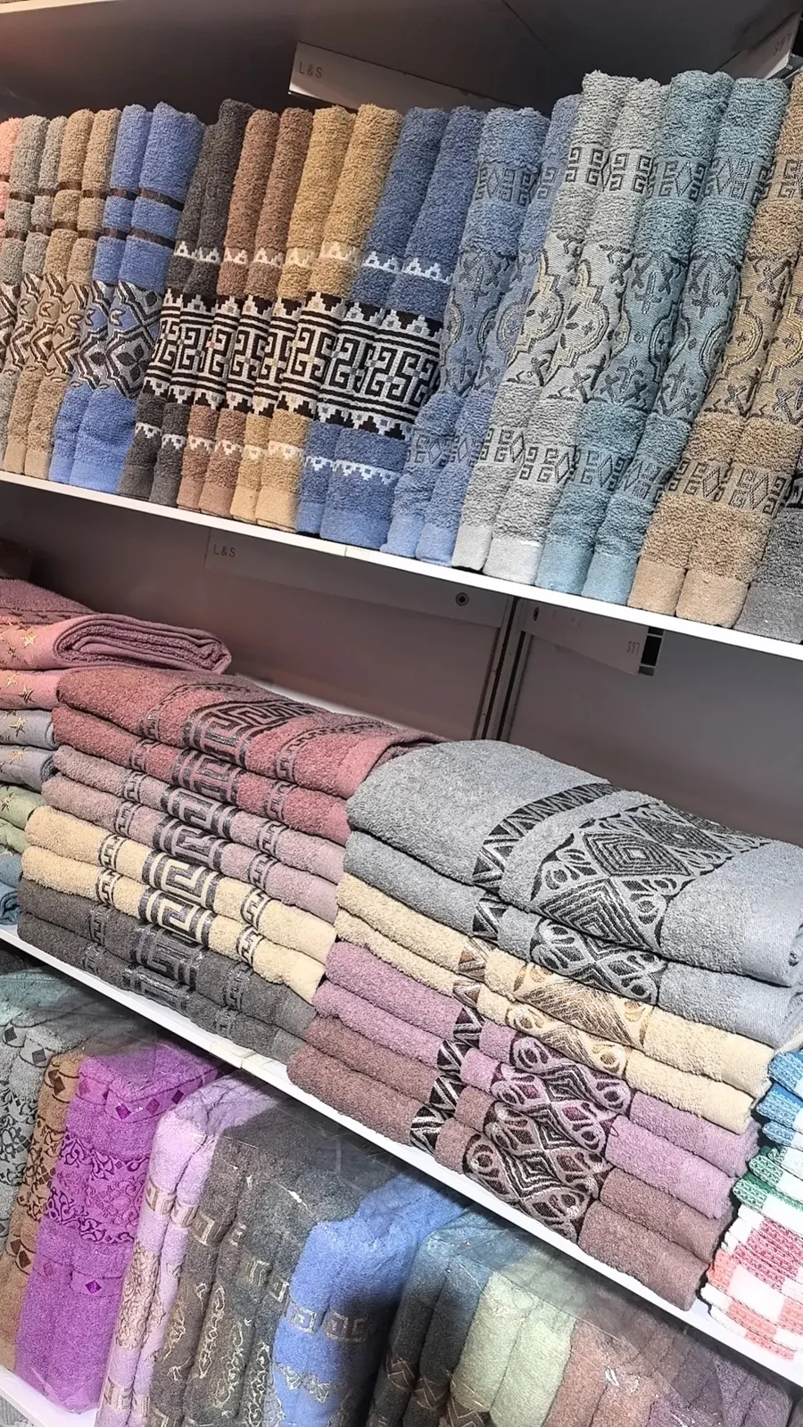 Folded towels on display shelves