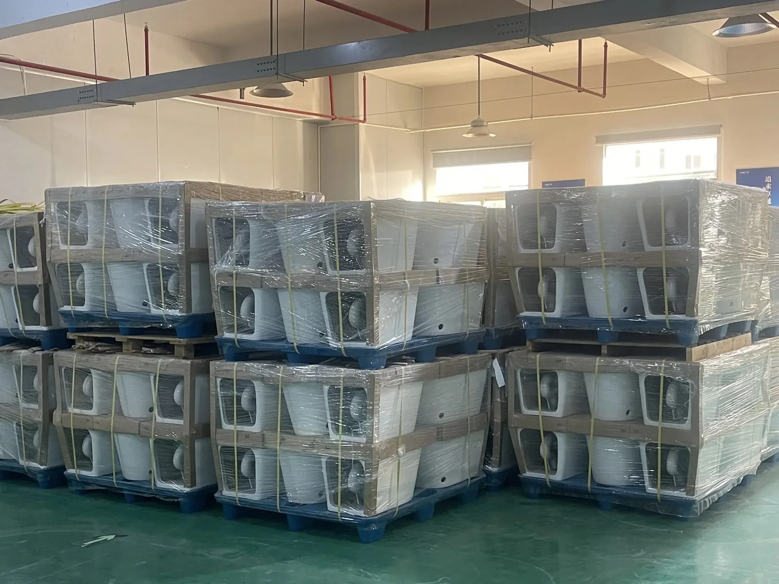 Wrapped sanitary ware stacked in a workshop