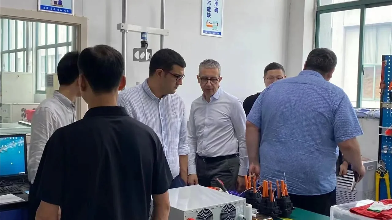 Visitors and supplier staff gathered around equipment and components for product review